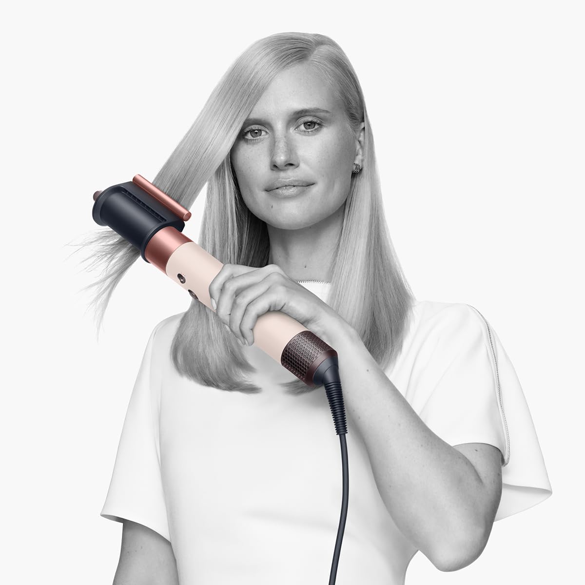 Woman with long straight hair using the Dyson Airwrap 560460-01 with the Coanda smoothing dryer attachment