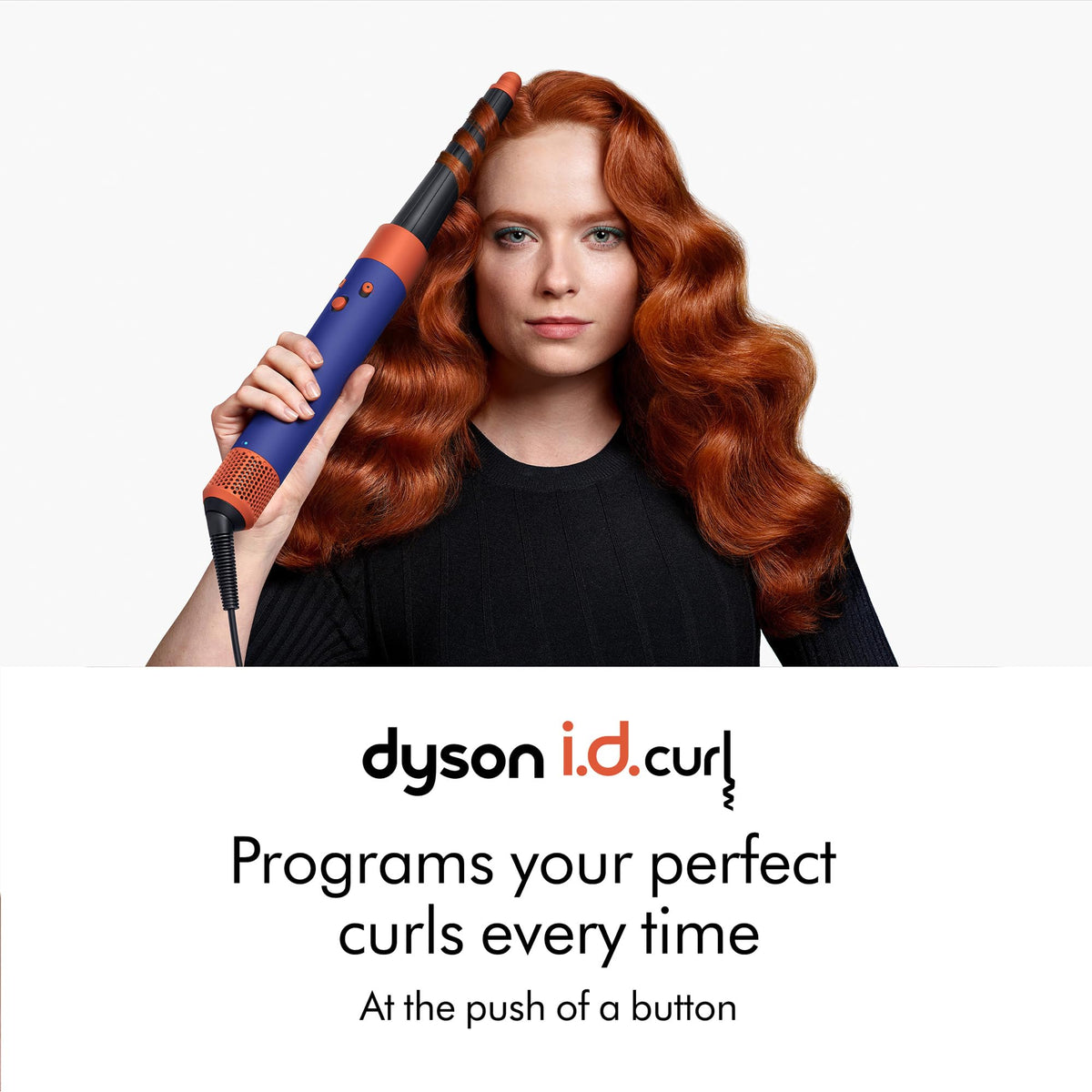 Woman with wavy copper hair curling with the Dyson Airwrap i.d. 533818-01 and i.d. curl