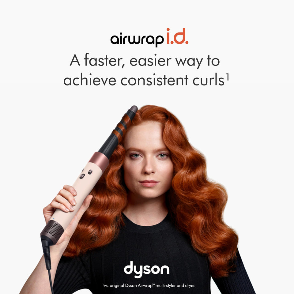 Dyson Airwrap i.d. 601904-01 curling barrel in use on long auburn wavy hair, with the line 'a faster, easier way to achieve consistent curls'
