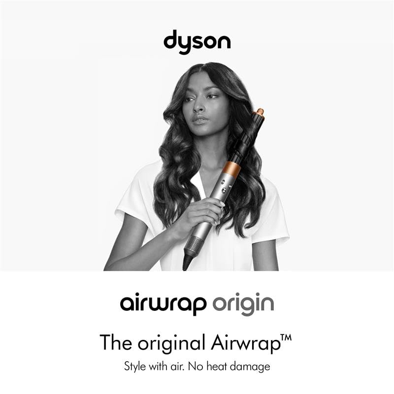Woman with wavy hair holding the Dyson Airwrap Origin multi-styler with the Airwrap barrel attached