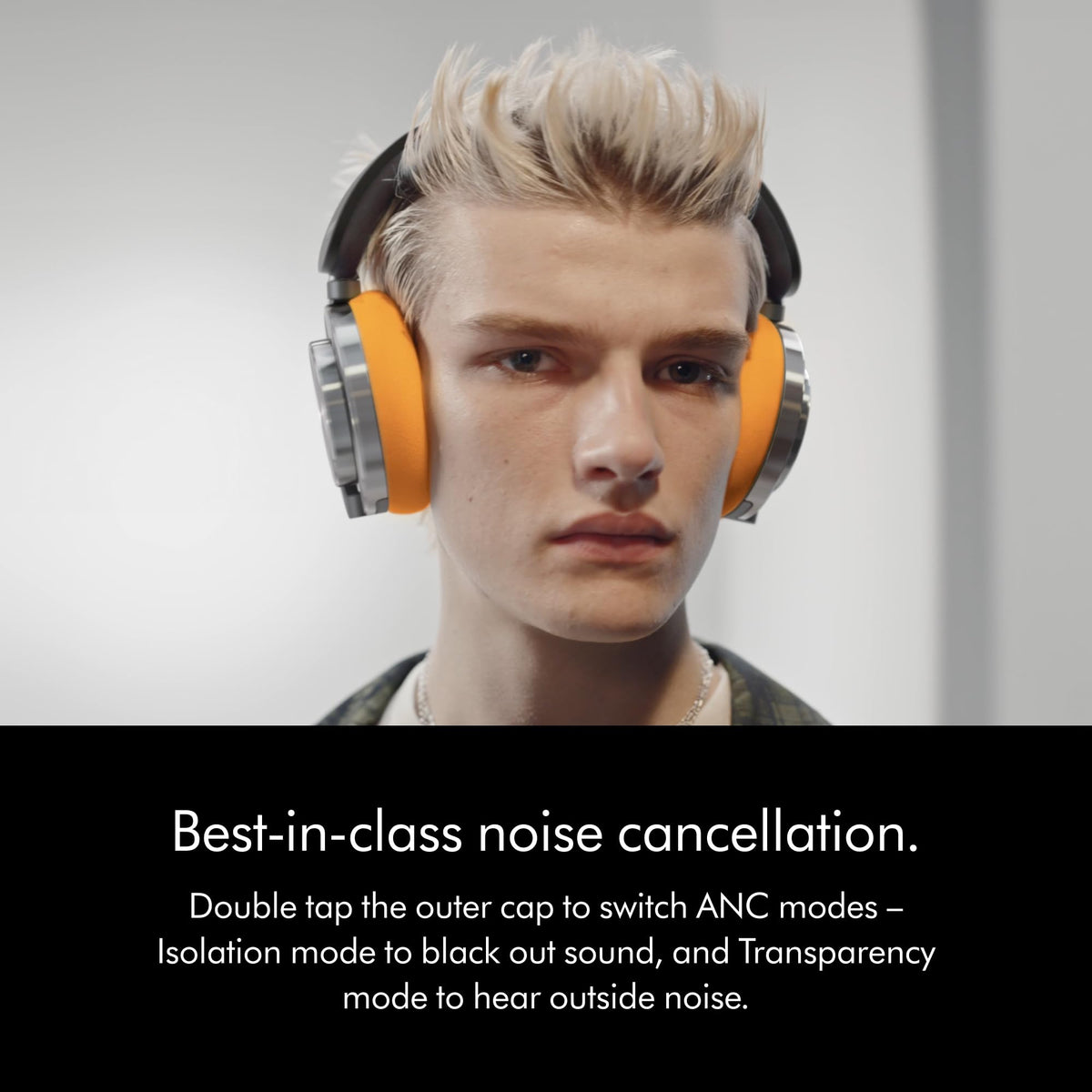 Person wearing Dyson OnTrac WP02 headphones with yellow cushions, highlighting double-tap noise cancellation modes