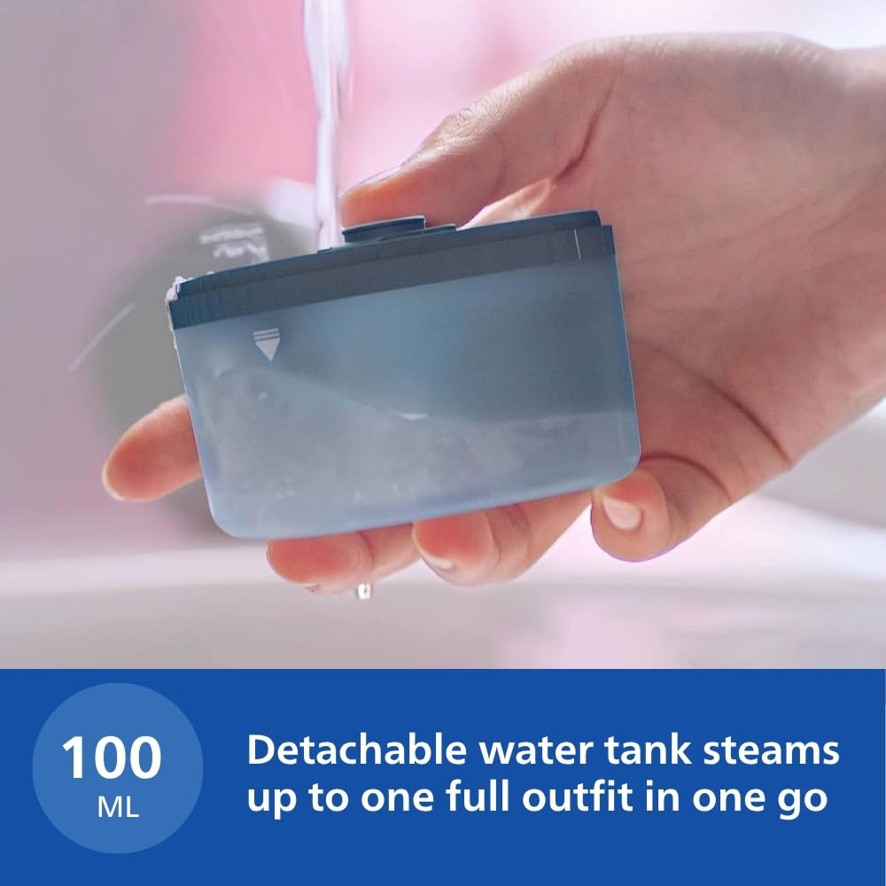 Hand holding the 100 ml detachable water tank of the Philips STH3000/20 under running water