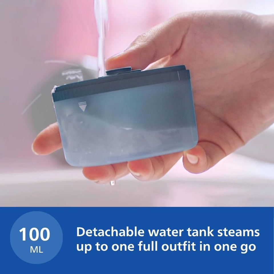 Hand holding the 100 ml detachable water tank of the Philips STH3000/20 under running water