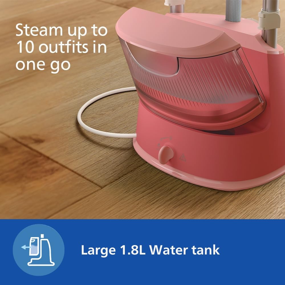 Philips STE1020/40 steamer base with the 1.8 L water tank fitted, standing on a wooden floor with the power cord coiled beside it