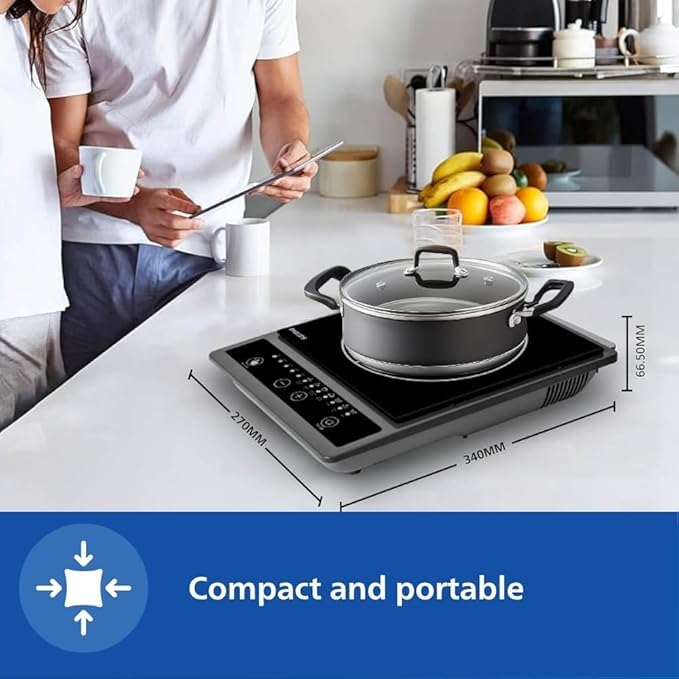 Philips HD4944/00 induction cooktop with a pot on a kitchen counter showing compact dimensions