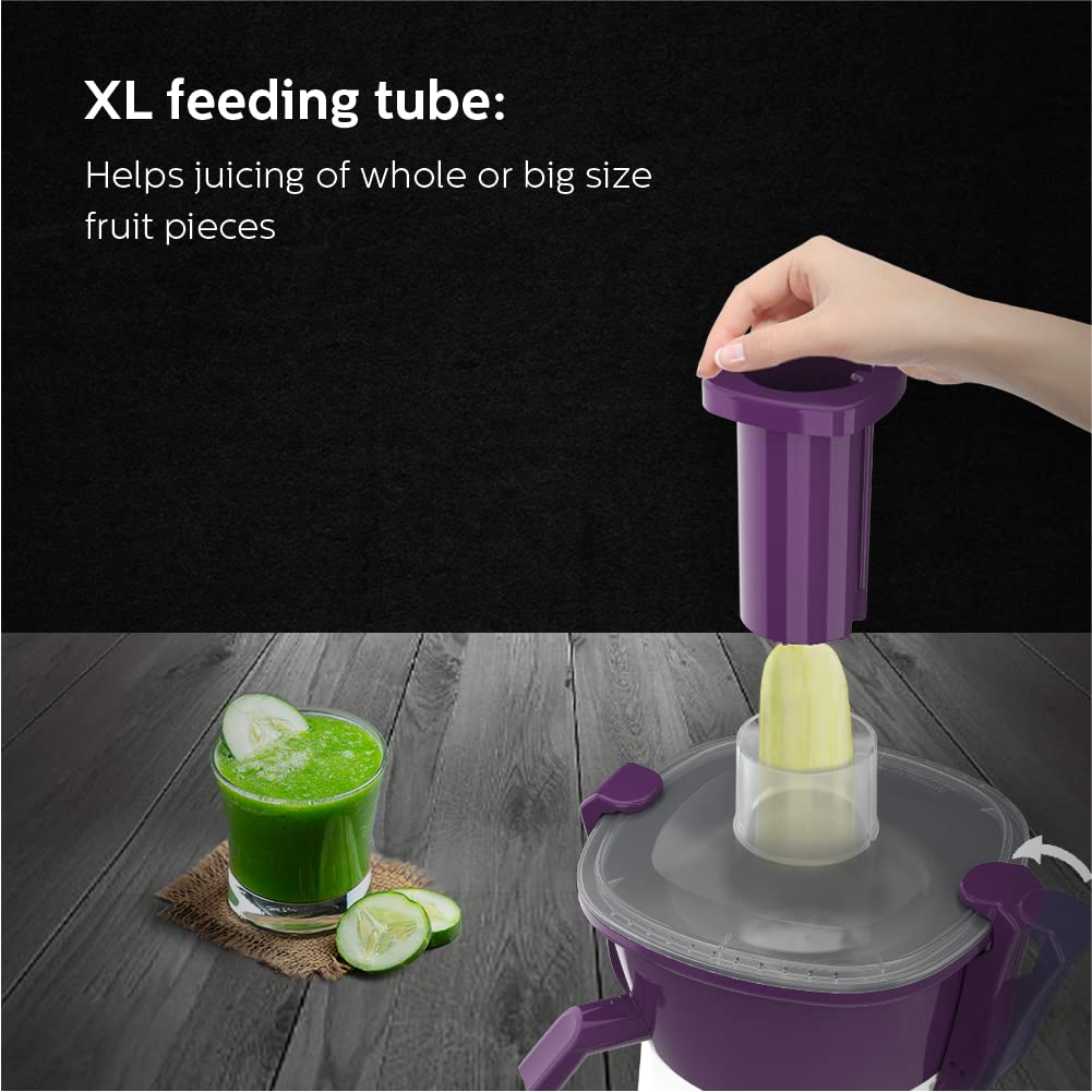Philips HL7567/01 XL feeding tube being fitted to the juicer with a cucumber piece and a glass of green juice