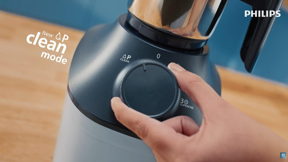 Hand turning the Philips HL7773/01 dial towards the Clean position, with a 'New Clean mode' callout