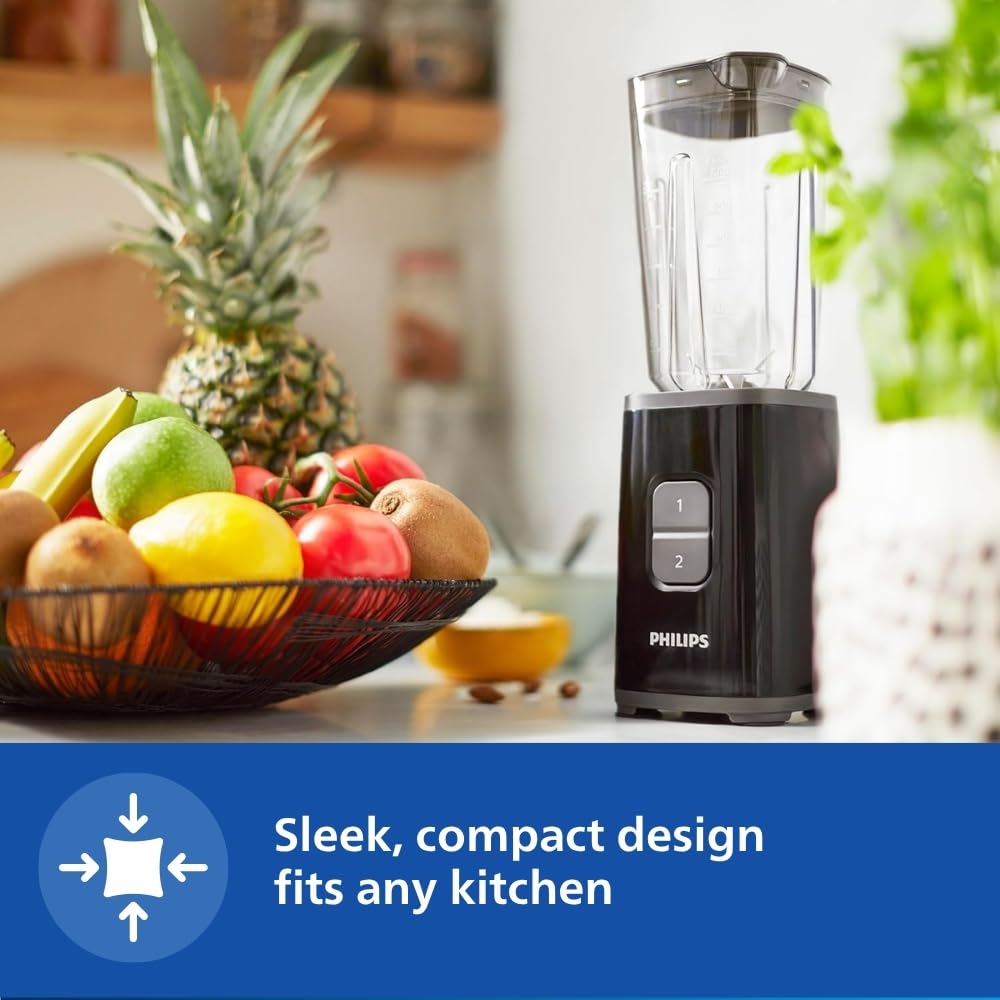 Philips HR2602/90 black mini blender on a kitchen counter next to a fruit basket, with a compact design callout