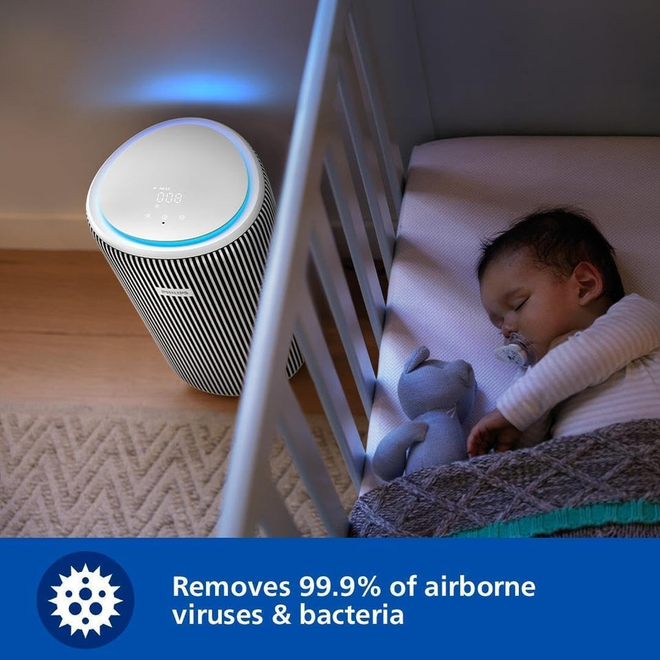 Philips AC3220/60 air purifier running with a blue glow in a nursery beside a sleeping baby in a cot
