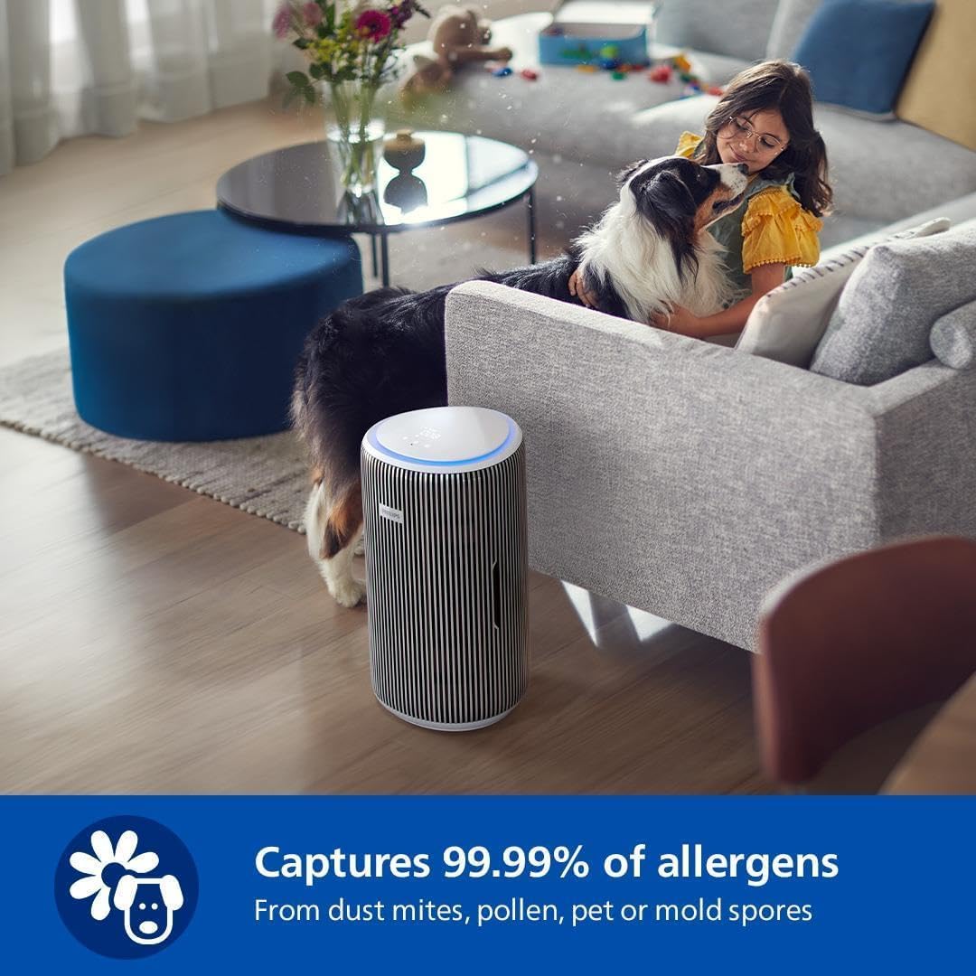 Philips AC3220/60 air purifier in a living room with a child and a dog on a sofa nearby