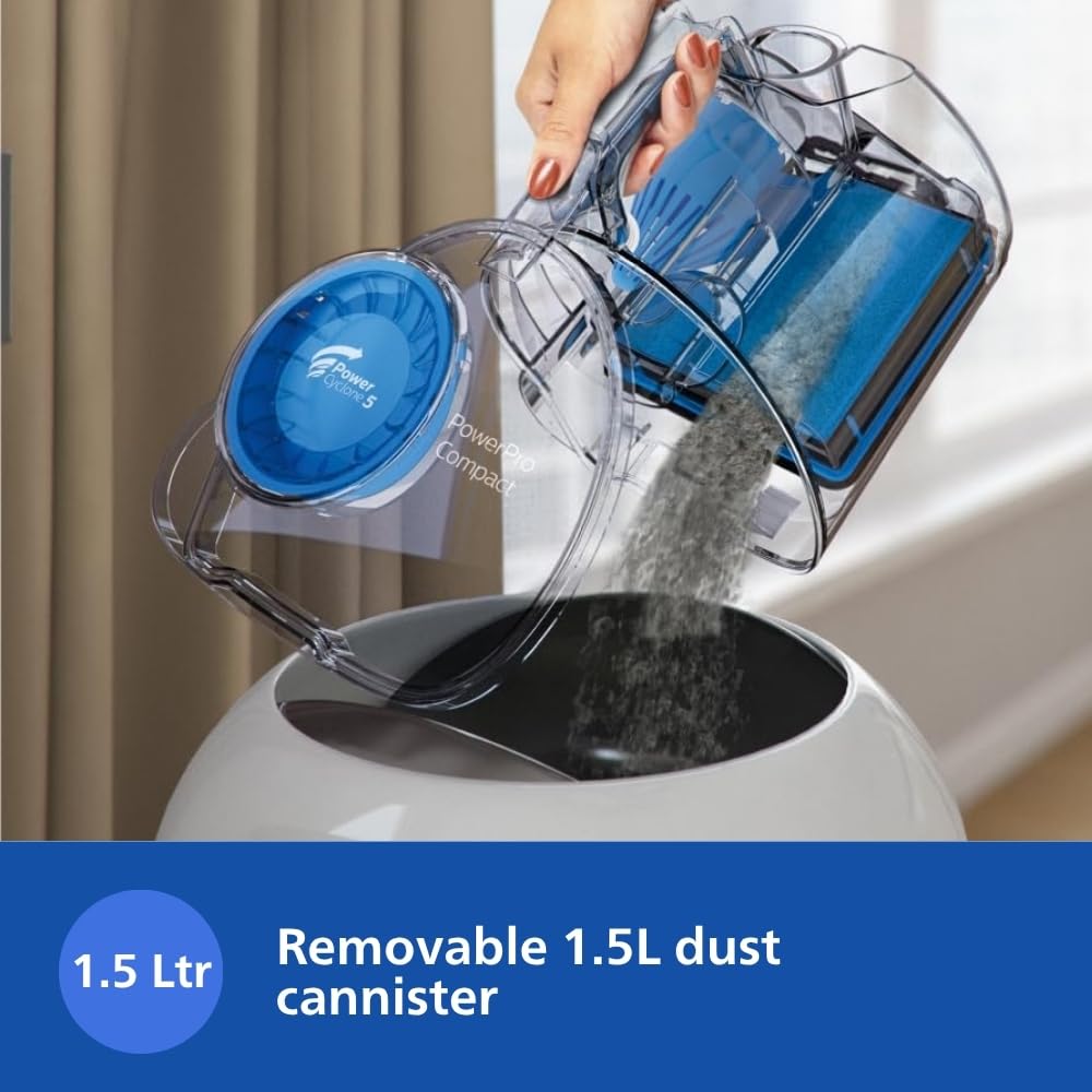 Philips PowerPro FC9352/01 removable 1.5 L dust container being emptied into a bin
